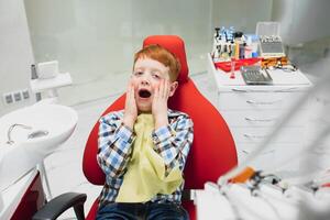 Boy satisfied with the service in the dental office. concept of pediatric dental treatment photo