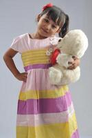 A Young Asian girl wearing dress photo