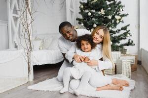 happy multiracial family with gifts at Christmas photo