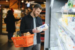 man in supermarket, grocery store customer photo