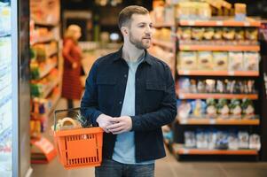 man in supermarket, grocery store customer photo