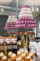 Delicious sweets on candy buffet. Table with sweets, buffet with cupcakes, Macaroons, candies, dessert photo