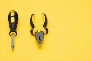 Carpenter tools set on yellow background, top view photo