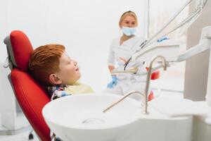 Female dentist and child in a dentist office photo