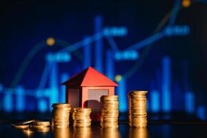 A pile of coins casting a shadow as house, savings concept photo