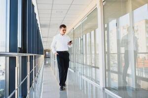 Businessman walking in the hall entrance photo