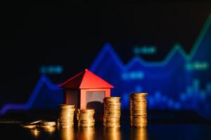 A pile of coins casting a shadow as house, savings concept photo