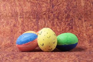 Colorful easter eggs on a brown background with copy space photo