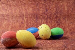 Colorful easter eggs on a wooden background. Easter holiday concept. photo