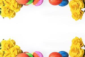 Colorful easter eggs and yellow roses on white background with copy space for text photo