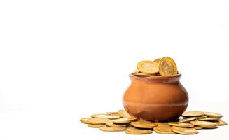 Gold coins in a clay pot on white background with copy space for text photo