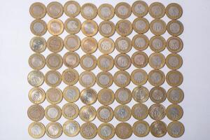 Top view of Indian ten rupee coins currency texture on white background photo