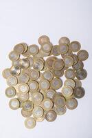 Pile of Indian ten rupee coins on white background photo