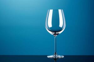 AI generated A single isolated wine glass on a blue surface and background. Copy space. photo
