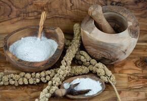 Dried millet flour on olive wood photo