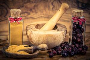 dietary supplement, dried rose hips on olive wood photo