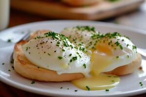 AI generated Poached white eggs on English muffins, garnished with chives and pepper, served on a plate, embody the appeal of gourmet brunch and culinary finesse. photo