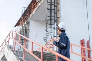 maintenance and inspector. Maintenance engineers are using walky talky to inform the results of inspection of buildings and structures. Irrigation engineers are exploring sluice systems photo