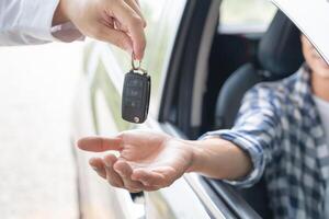 lease, rental car, sell, buy. Dealership manager send car keys to the new owner.  Sales, loan credit financial, rent vehicle, insurance,  renting, Seller, dealer, installment, car care business photo