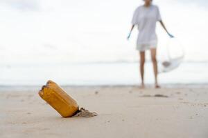 Save water. Volunteer pick up trash garbage at the beach and plastic bottles are difficult decompose prevent harm aquatic life. Earth, Environment, Greening planet, reduce global warming, Save world photo