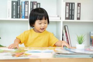 Happy Asian children relax read book at home. daughter and reading a story. learn development, childcare, laughing, education, storytelling, practice, imagine, reduce addiction mobile phone photo