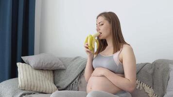 Balanced diet and weight monitoring of a pregnant woman. Calcium as a necessary trace element for fetal development. Pregnant woman eats banana and fruit video