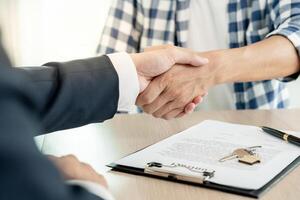 lease, rental and selling home. Dealership manager smile handshake to the new homeowner. rent house, Sales, loan credit financial, insurance, Seller, dealer, installment photo