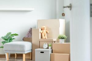 Moving house, relocation. The key was inserted into the door of the new house, inside the room was a cardboard box containing personal belongings and furniture. move in the apartment or condominium photo