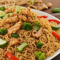 AI generated a plate of noodles with chicken and vegetables photo