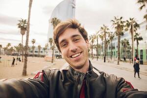 Young man taking a photo of himself