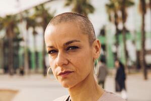 serious bald woman outdoor portrait photo