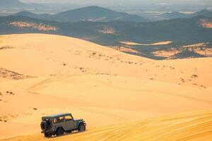 AI generated Adventure in Vietnam Jeep car on Mui Ne sand dunes photo