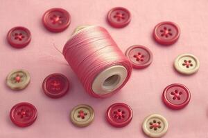 AI generated Beautiful texture with pink buttons and a coil for sewing photo