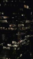 Aerial view of an office tower with illuminated empty offices at night. video