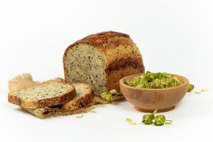 Organic bread of whole grain flour and hop sourdough. Dry hop flowers in wooden bowl and homemade bread. Craft bakery concept photo