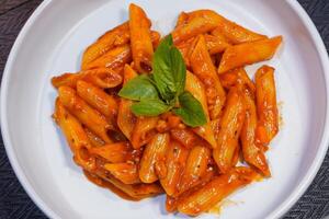 penne pasta with shrimps, tomato sauce photo