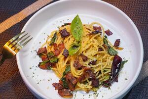 Spicy spaghetti with dried Chili and fried bacon photo