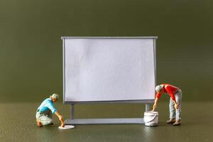 Tiny figures , A blank canvas and an imaginative artist brainstorming ideas in an art class or studio photo