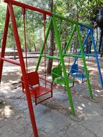 swing in the garden, empty swings in the playground, colorful swings in the city park Salatiga, central java photo