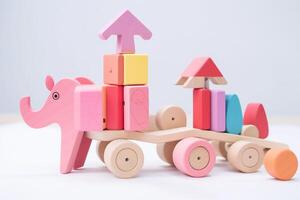 AI generated Soft pink and colorful round wooden construction blocks, shapes, elephant for building a children's toy for playing. Brain and skill developing. White background. Copy space. photo