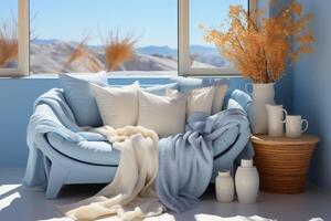 Light blue and beige sofa, blanket and pillow, vases by window and desert view in background photo