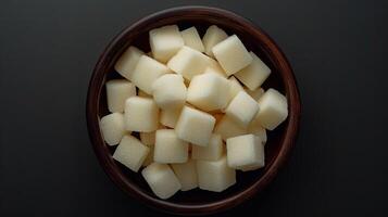 ai generado de madera cuenco lleno con cubicado patatas en mesa foto