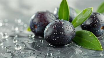 ai generado Tres negro aceitunas con verde hojas en un plata superficie foto