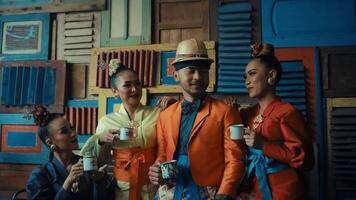 Stylish group of friends enjoying coffee together in a colorful, vintage setting. video