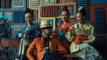 Stylish group of people with face masks drinking coffee in a colorful, retro setting. video