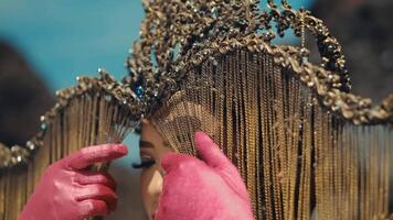 Woman with elaborate headpiece and makeup, looking away thoughtfully. video