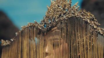 Close-up of a golden chain mail piece with a blurred background. video