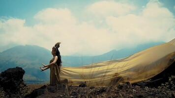 Woman in flowing dress with mountains in background. video