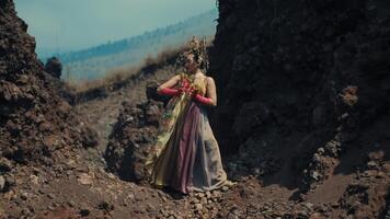 Woman in elegant dress walking through rugged terrain. video