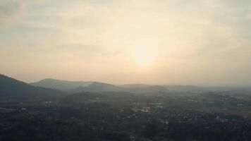 Serene sunrise over misty mountains with a soft, golden glow in the sky. video